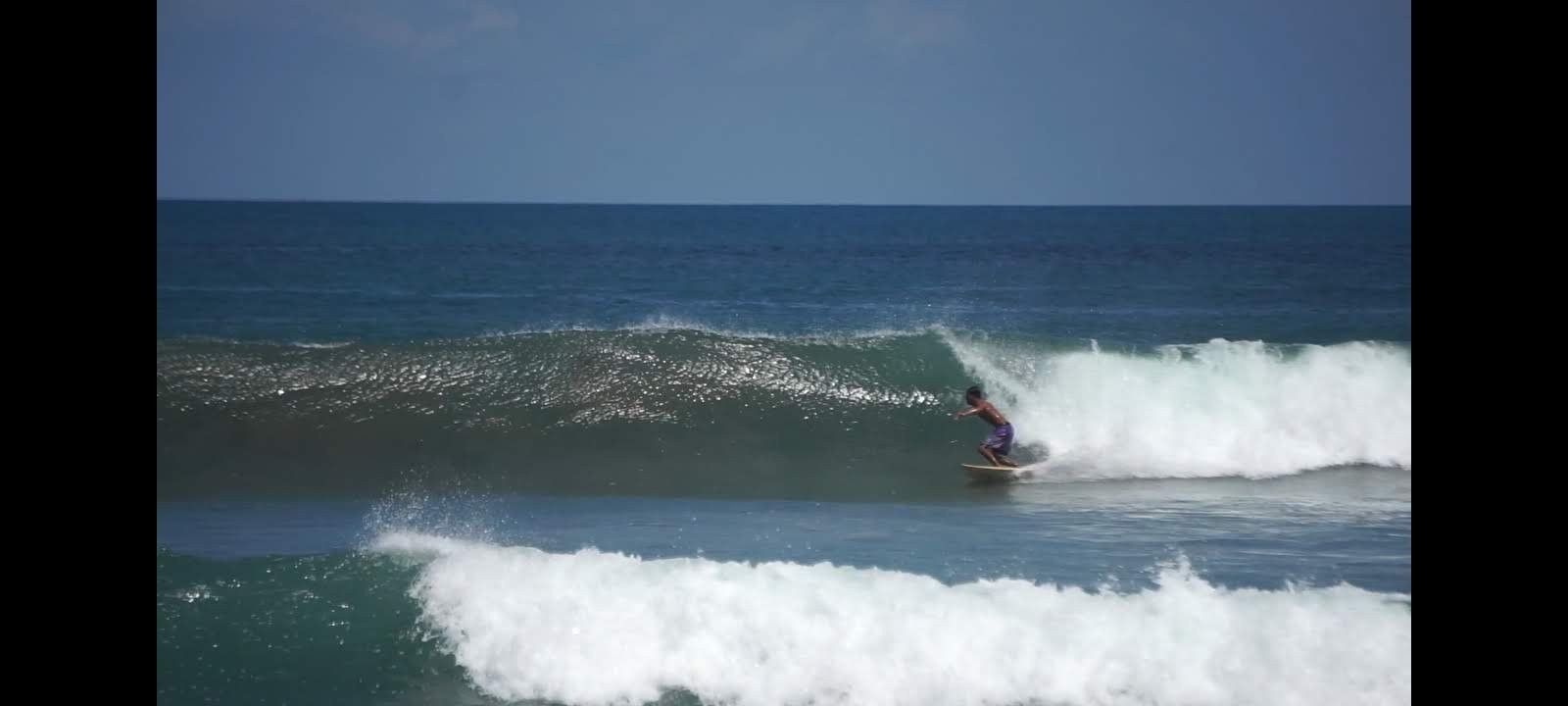 Surfer riding a wave in Bali